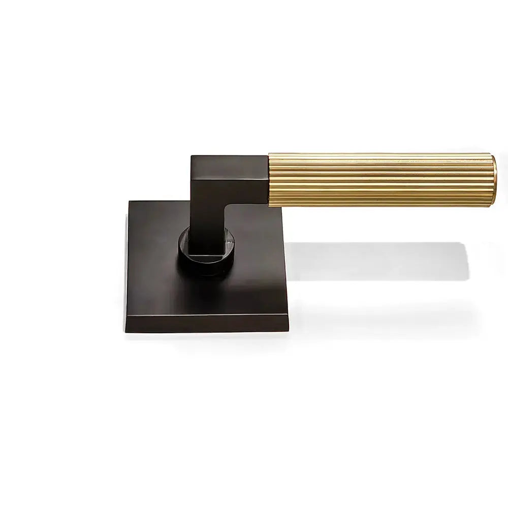 Black and gold square locking plate pulls straight knurled doorknob flat on the ground