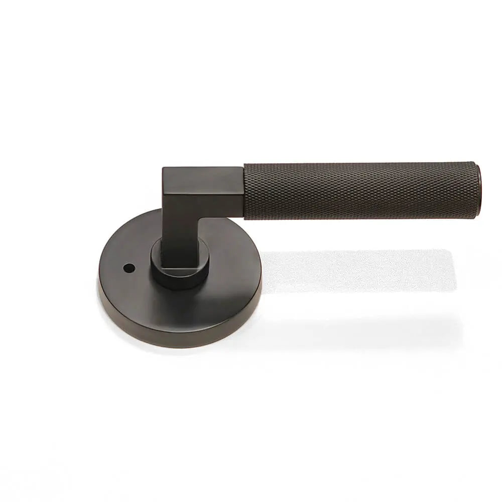 Black round locking plate with full knurled door handle on the floor