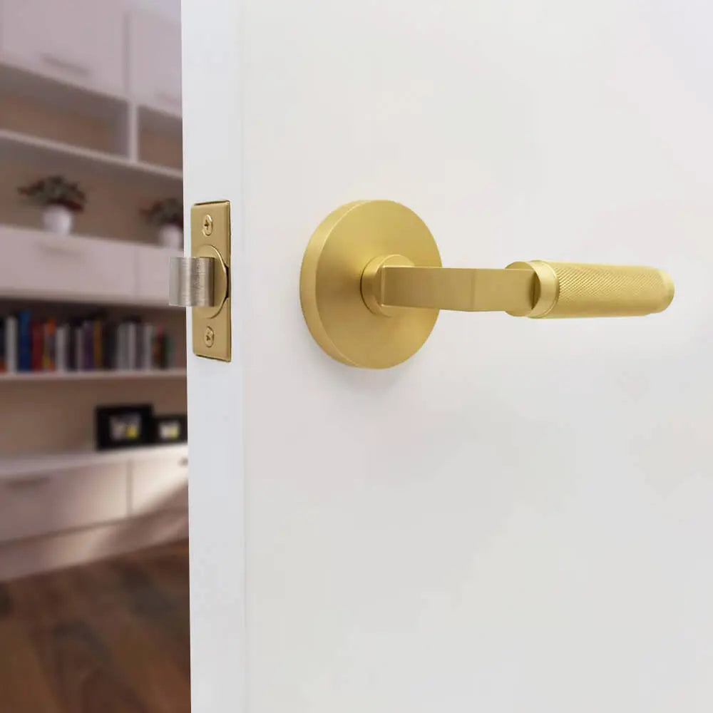 Gold color round lock plate half-knurled door handle fitted to the door
