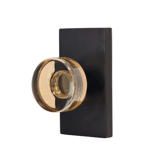 Decorative door handle with black square plate on a white background